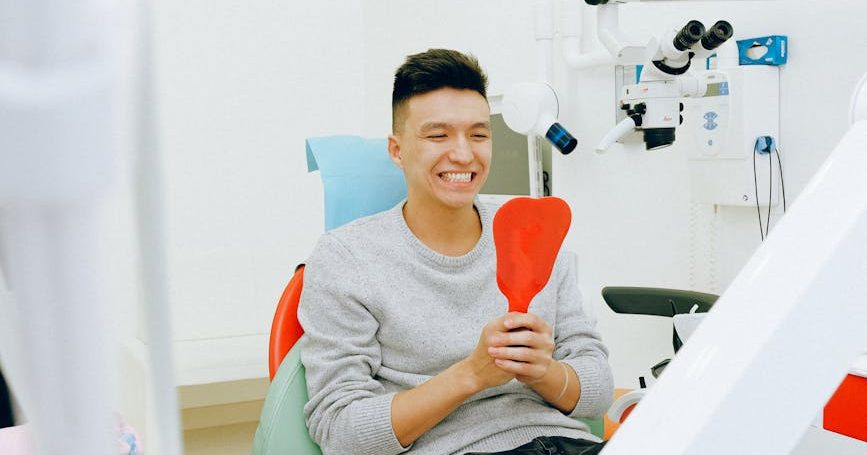 man sitting on dental chair